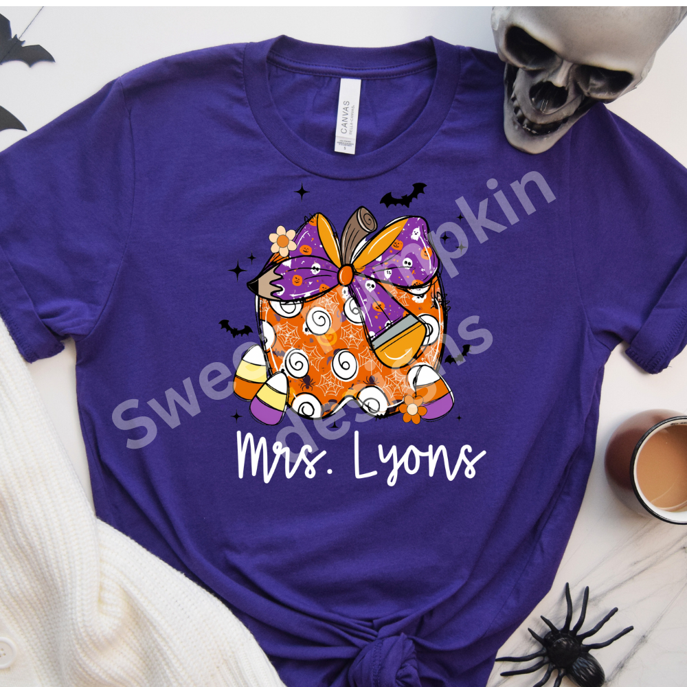 Personalized fall teacher t-shirt for Halloween with candy corn and apple graphic, perfect for school spirit and classroom celebrations.