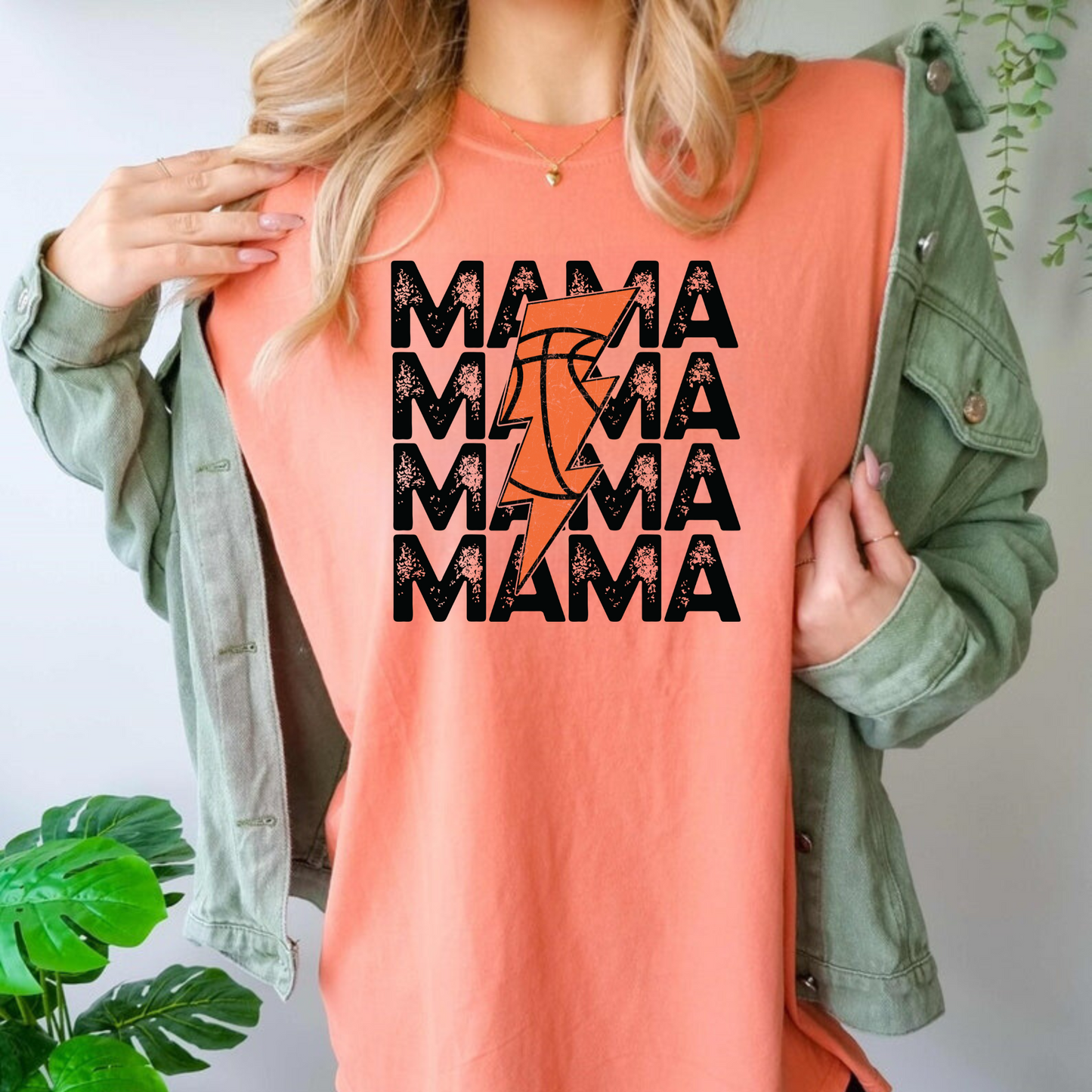 An oversized comfort colors t-shirt for basketball mamas featuring a retro basketball and lightning bolt design. This basketball mom shirt is ideal for game day, offering a stylish and comfortable outfit choice with a vintage-inspired twist.