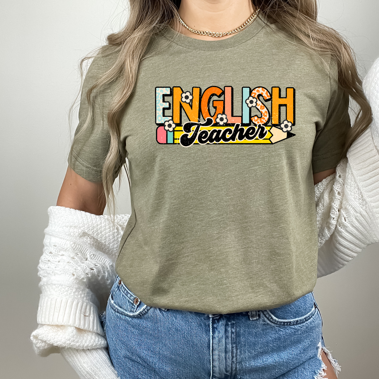 A retro-inspired English teacher shirt with a stylish graphic design. This cute and cool shirt is perfect for English teachers looking to showcase their passion for teaching. Shop now and add this trendy and comfortable graphic tee to your teacher wardrobe.