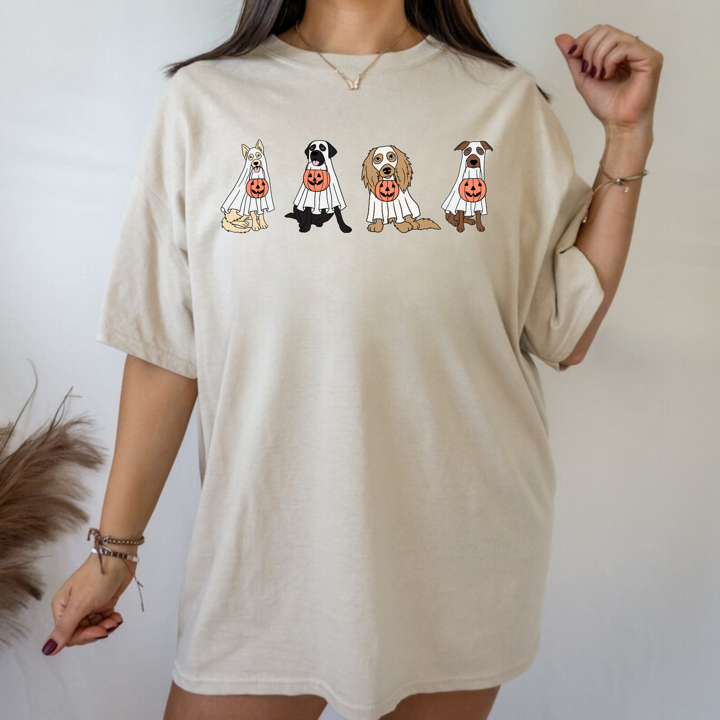 An oversized comfort colors shirt adorned with charming ghost dogs, capturing the essence of a cute and spooky Halloween. Ideal for dog lovers, this trendy shirt brings a touch of autumn to your wardrobe, making it a must-have for the fall season.