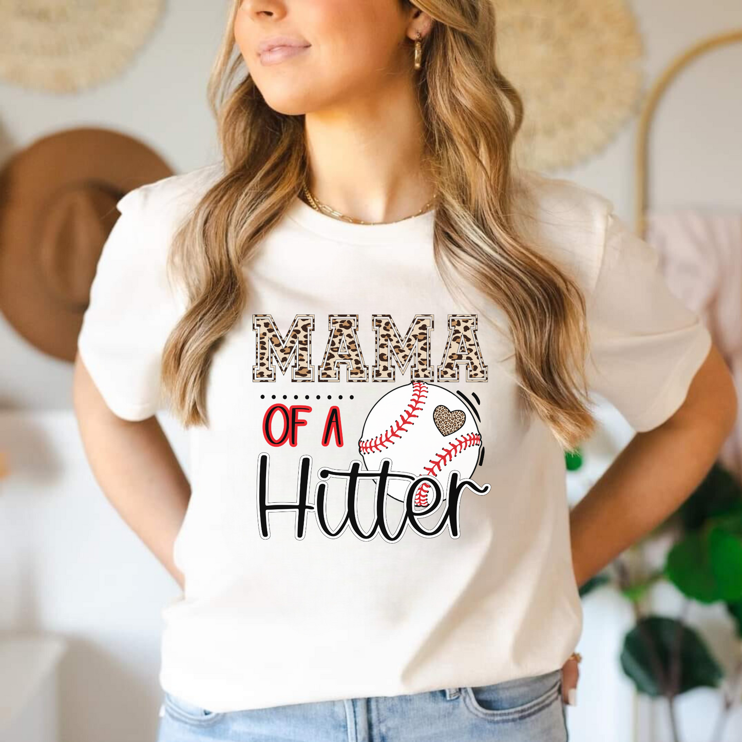 Baseball Mom Shirt with the phrase 'Mom of a Hitter' in trendy leopard print. A cute and stylish graphic tee for baseball game days and proud baseball moms. Perfect for showcasing team spirit and fashionable support.