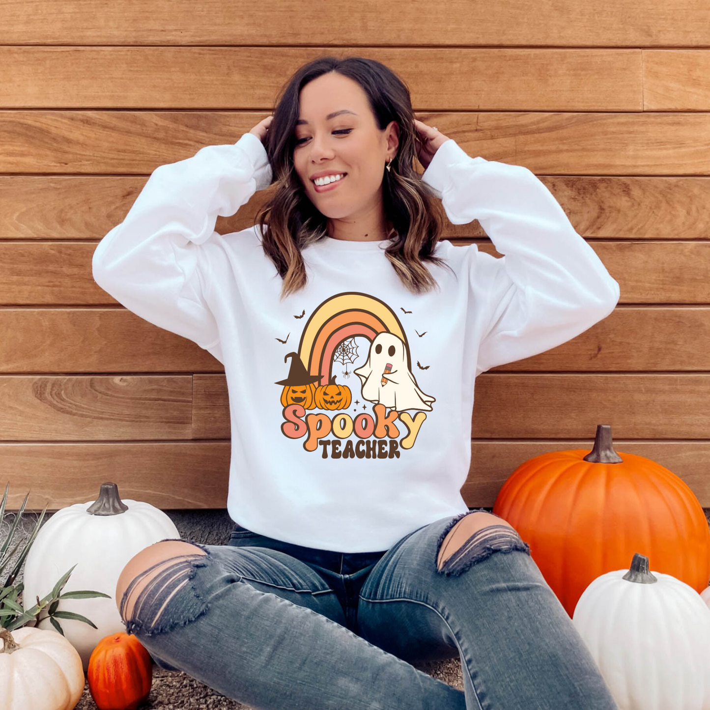 A cozy Halloween teacher sweatshirt, perfect for embracing the seasonal spirit while maintaining a professional teacher style. The sweatshirt features Halloween-themed design elements that add a touch of festive charm to your fall teacher outfit.