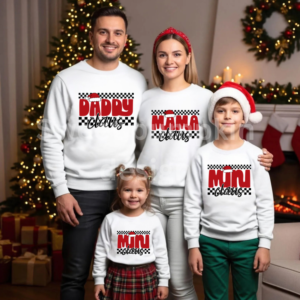 Family of four wearing matching Christmas-themed sweatshirts in a festive living room.