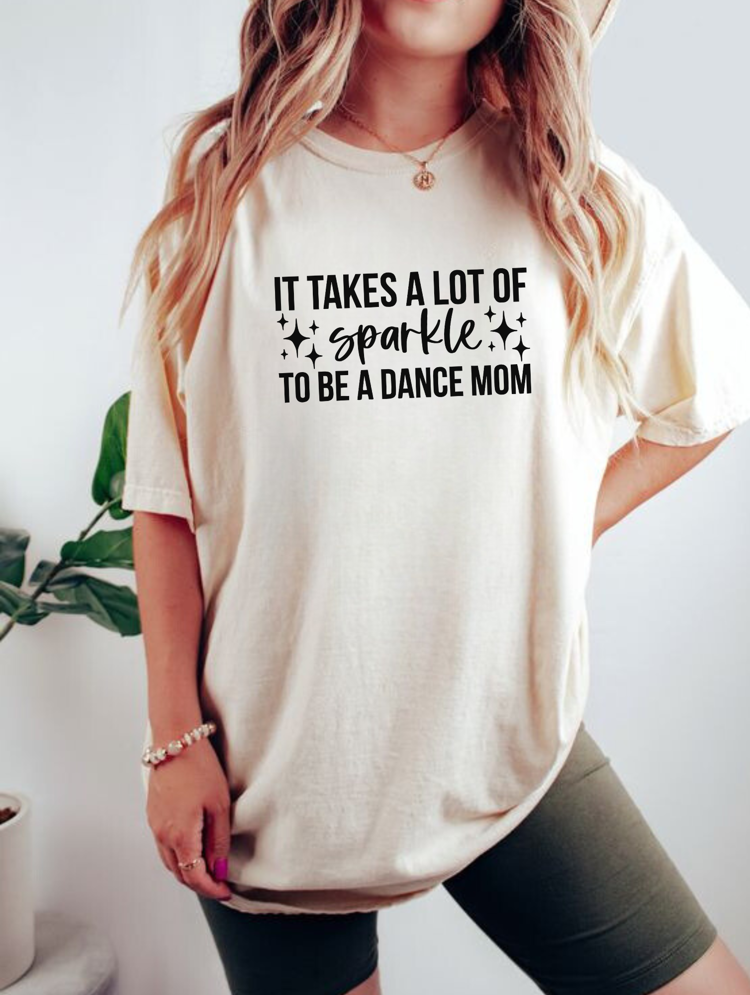 An image of a cute and stylish oversized Dance Mom shirt with a design that represents the pride and enthusiasm of being a dance competition mom. Perfect for joining the dance mom squad or club, this shirt also makes a great gift. The shirt is made of high-quality Comfort Colors fabric and is designed for comfort and style.