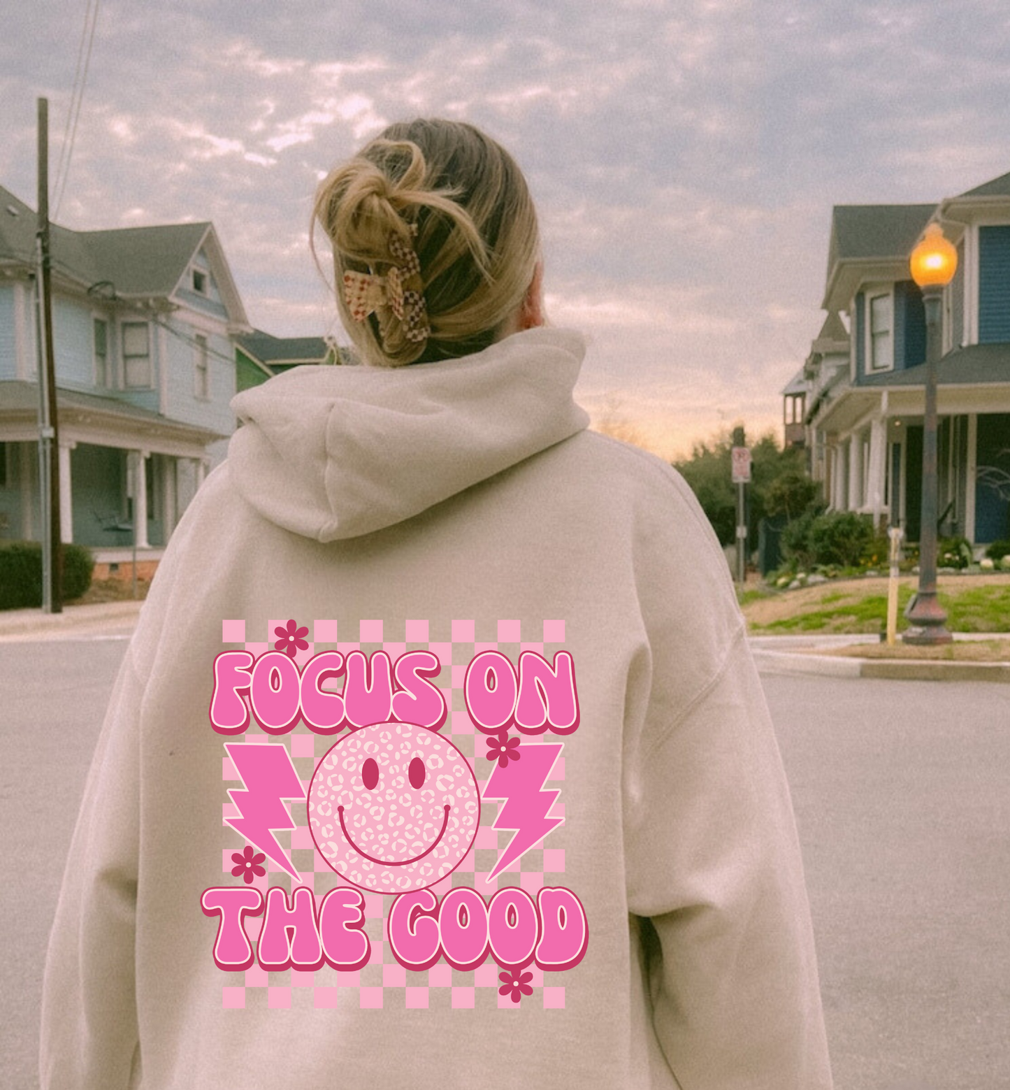 Oversized preppy hoodie with a smiley face design on the back that says 'Focus on the good'. The hoodie exudes a trendy y2k aesthetic, perfect for those seeking comfortable and stylish preppy clothing.