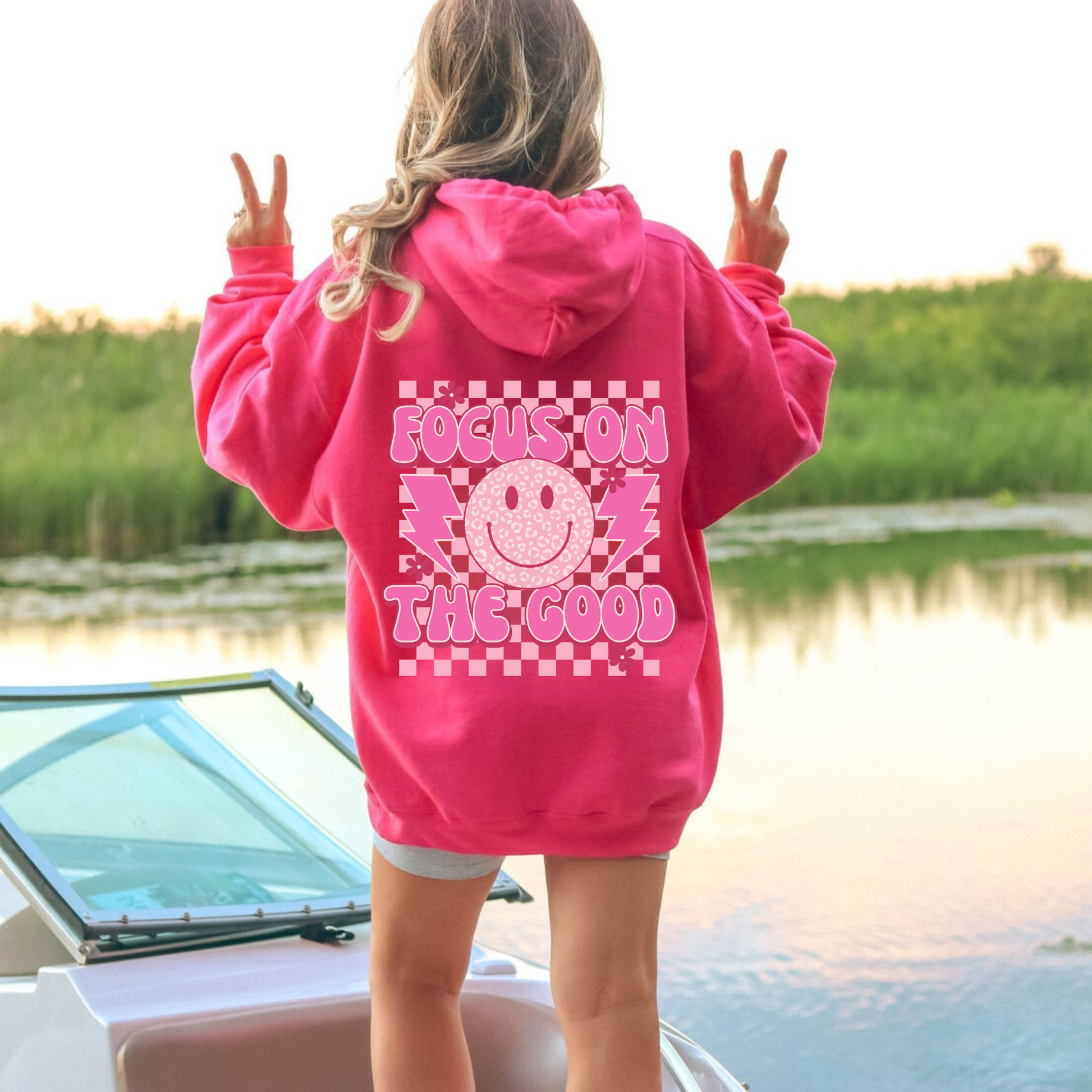 Oversized preppy hoodie with a smiley face design on the back that says 'Focus on the good'. The hoodie exudes a trendy y2k aesthetic, perfect for those seeking comfortable and stylish preppy clothing.