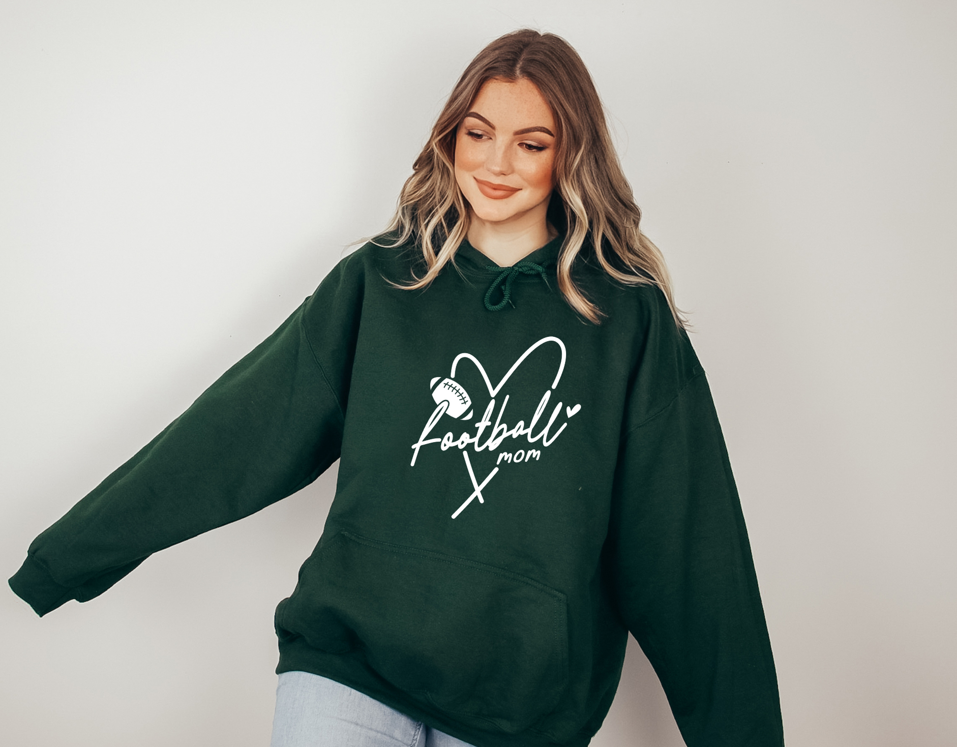 Stay cozy and comfortable while rooting for your football star with our football mom hoodie sweatshirt. Crafted for both comfort and style, this hoodie is the ultimate choice for chilly football game days. Show your support for your athlete while staying warm in this essential hoodie. Stay comfy and stylish as a proud football mama, all while enjoying the excitement of the game!