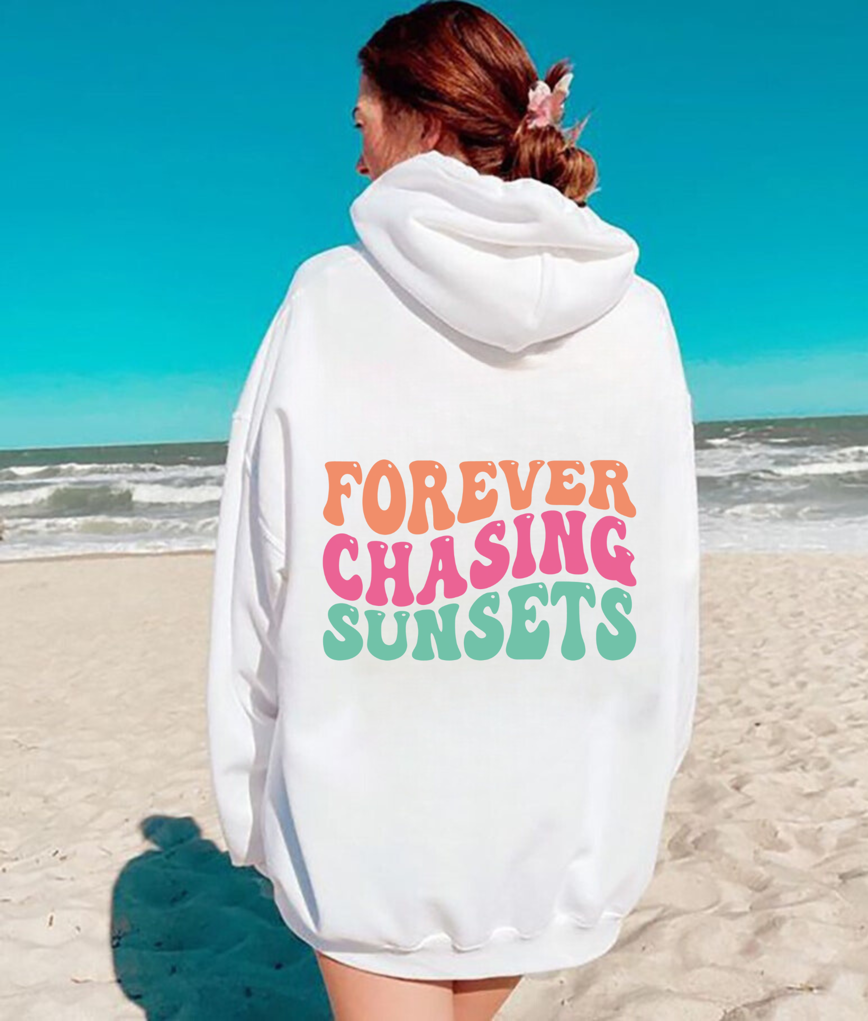 "Forever Chasing Sunsets" oversized beach hoodie sweatshirt for women, featuring a graphic print and relaxed fit. Perfect for beach outings and summer vibes.