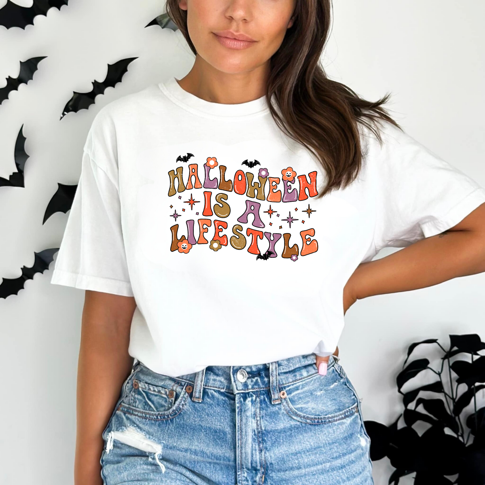 A retro Halloween shirt with the text 'Halloween Is A Lifestyle', featuring a design that captures the essence of the spooky season. The shirt adds a touch of autumn charm and Halloween aesthetic to your fall outfit.