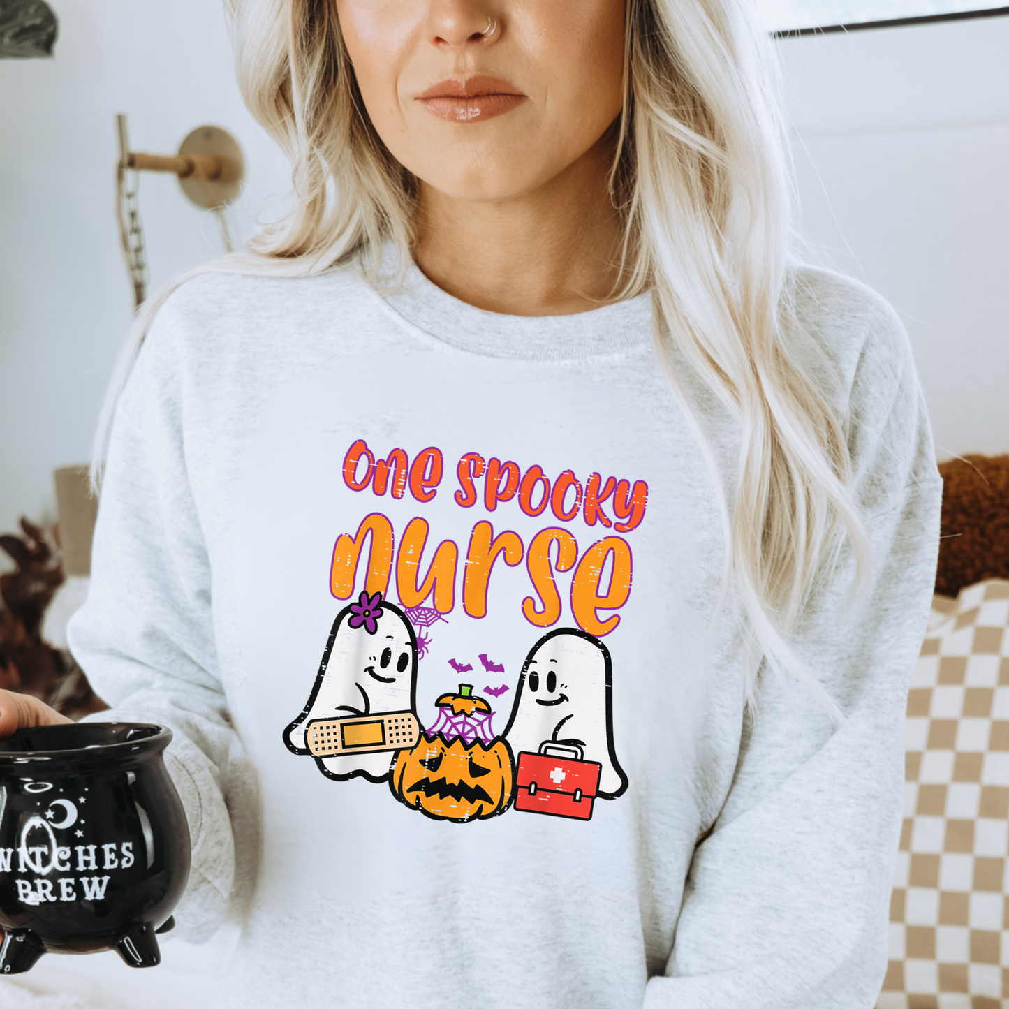 Get into the festive spirit with our spooky Nurse Halloween Crewneck Sweatshirt. This Halloween nurse sweater is the perfect addition to your nurse work outfit, featuring a fun and stylish design for Halloween. Elevate your nurse clothes collection with this adorable nurse sweatshirt, specifically crafted for the spooky season. Shop now and rock the perfect Halloween shirt for nurses to make a fashionable statement this Halloween!
