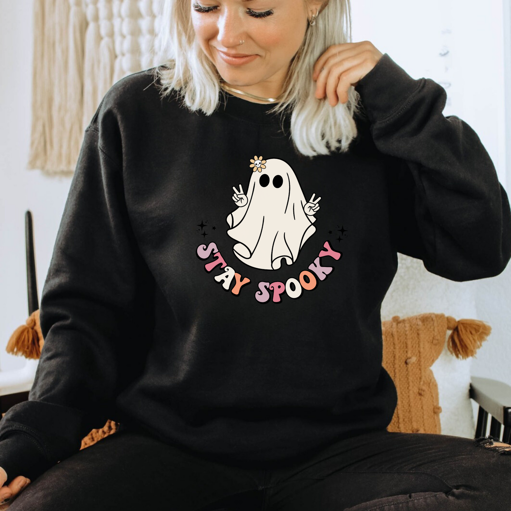 Our Retro Vintage Halloween Sweatshirt Crewneck with a cute hippie ghost design and "Stay Spooky" slogan is perfect for any Halloween enthusiast. Made with high-quality materials, this comfortable crewneck sweatshirt is durable and built to last. This sweatshirt is also a great gift for birthdays, holidays, or any special occasion. Show off your spooky side and add a touch of retro Halloween style to your wardrobe. Shop now and embrace the Halloween spirit!