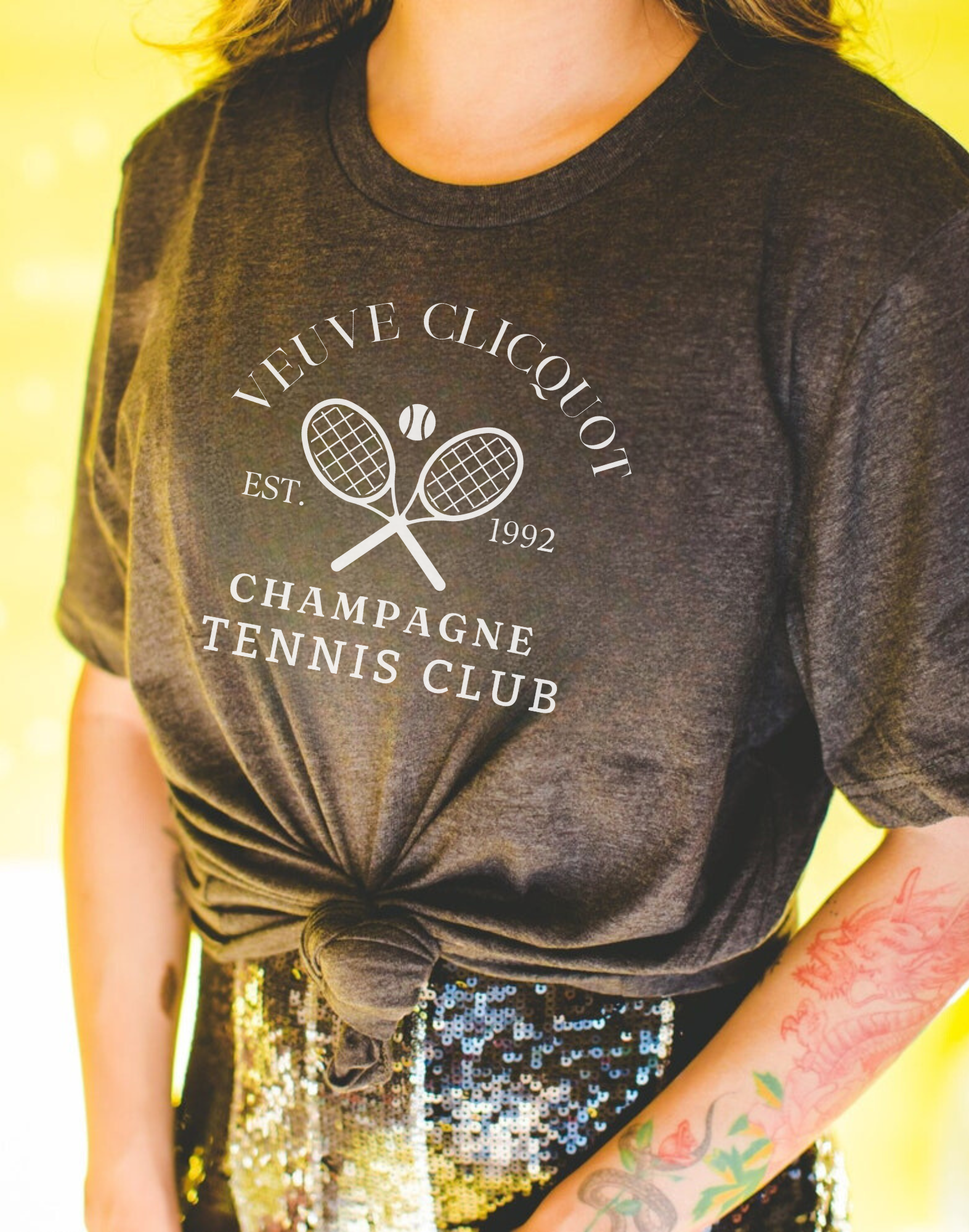 A champagne tennis shirt with a classic and preppy design, perfect for a sophisticated summer outfit.